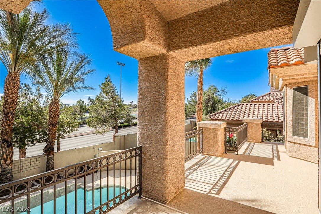 1828 Dolce Drive, Las Vegas, NV 89134 A spacious outdoor terrace offers a private pool and views of mature palm trees.