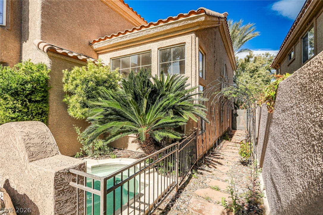 1828 Dolce Drive, Las Vegas, NV 89134 A secluded patio with a private spa and lush plantings, perfect for tranquil relaxation.