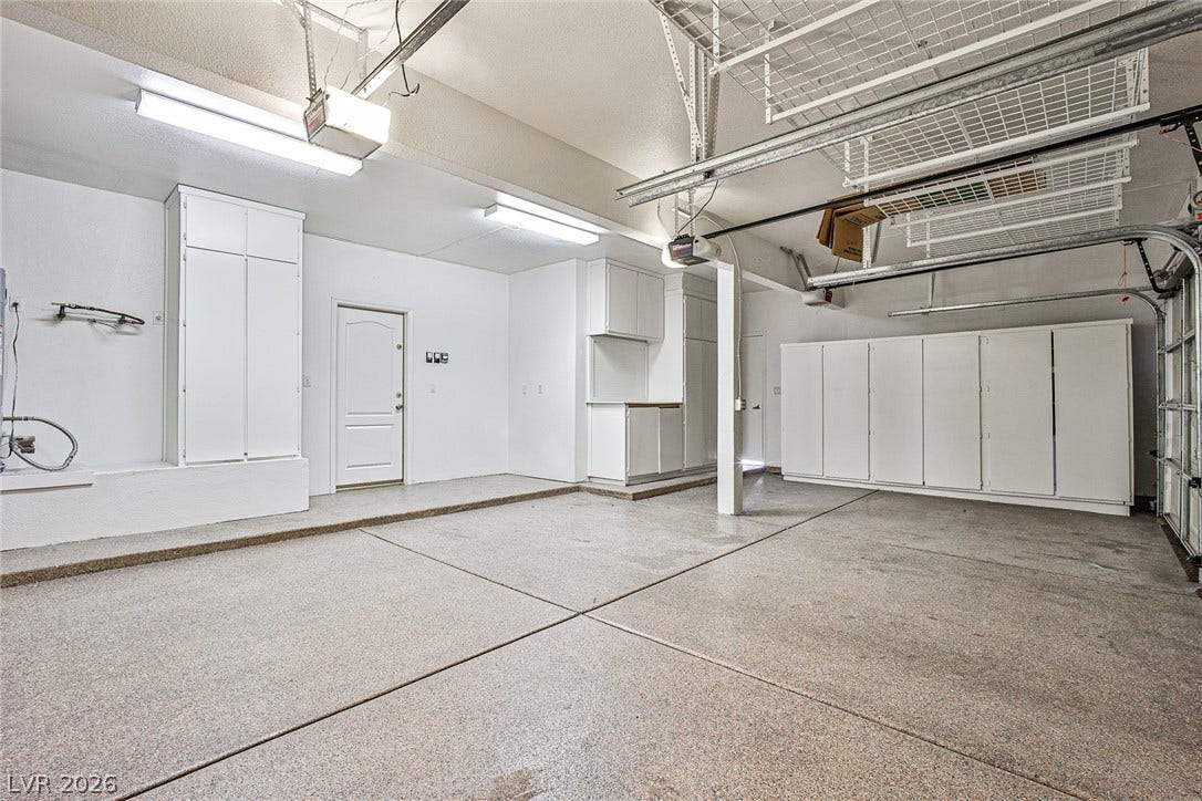 1828 Dolce Drive, Las Vegas, NV 89134 A clean, functional garage with ample built-in storage solutions and overhead shelving.