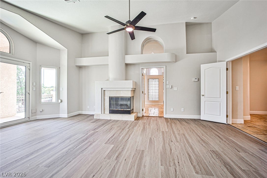 1828 Dolce Drive, Las Vegas, NV 89134 An inviting living area with a grand fireplace and vaulted ceilings welcomes residents.