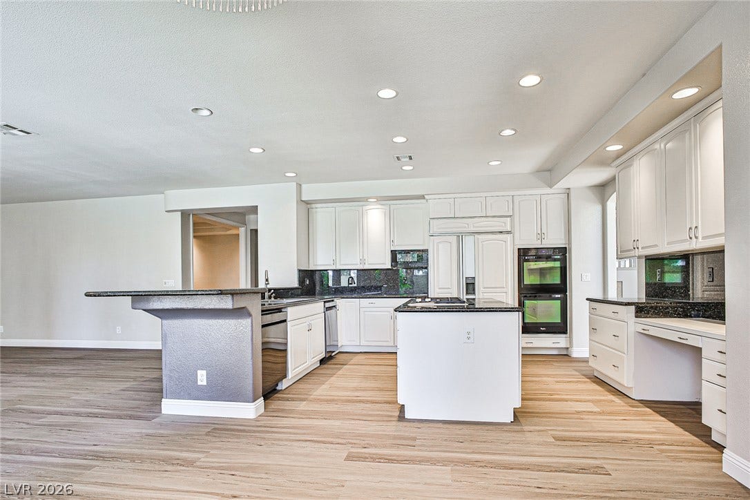 1828 Dolce Drive, Las Vegas, NV 89134 An open concept kitchen features abundant cabinetry, granite countertops, and modern appliances.
