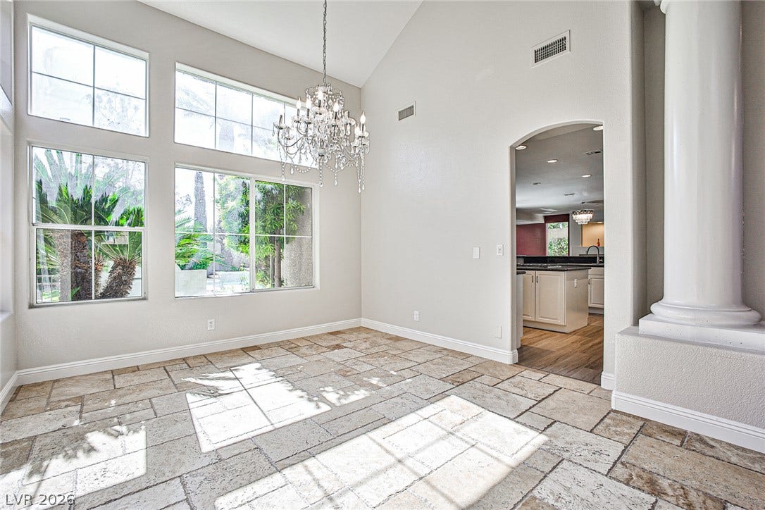 1828 Dolce Drive, Las Vegas, NV 89134 Voluminous ceilings and natural light fill this versatile living area, flowing into a well-appointed kitchen.