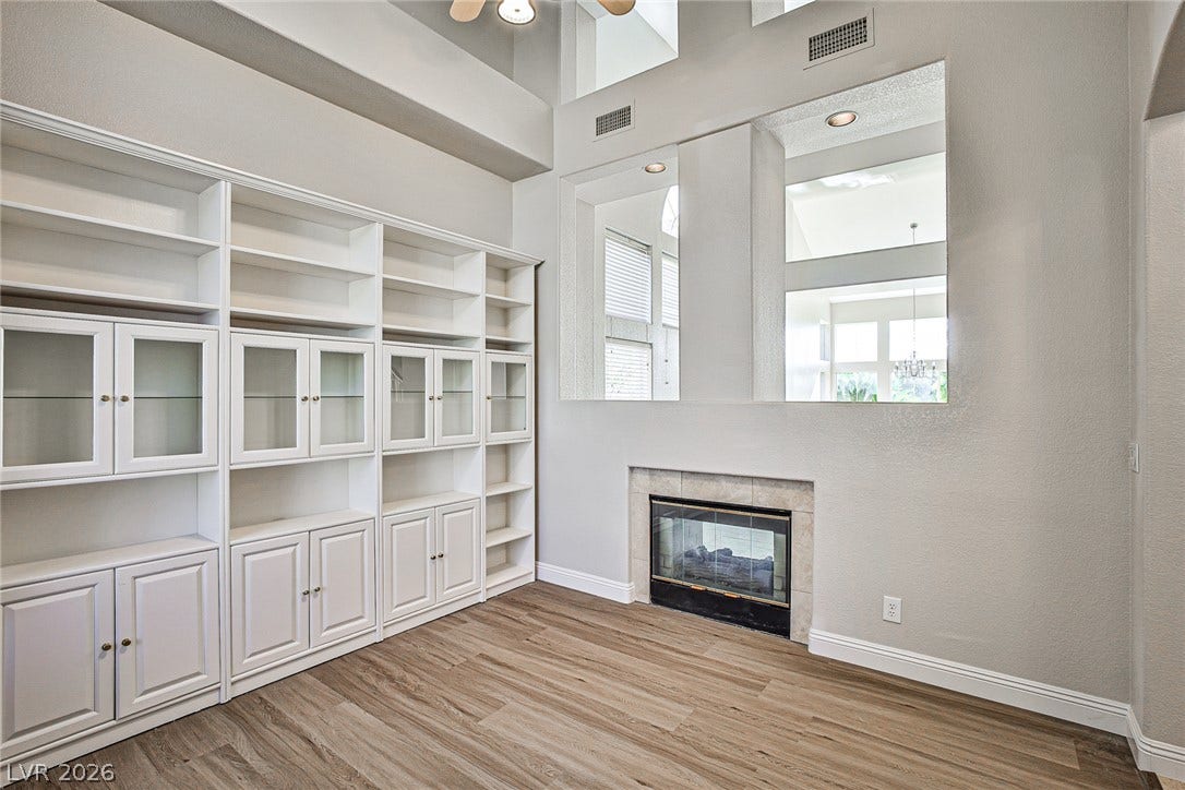 1828 Dolce Drive, Las Vegas, NV 89134 Built-in shelving and a cozy fireplace create a comfortable, inviting living space.