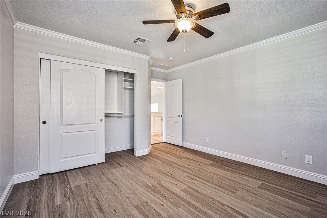 1828 Dolce Drive, Las Vegas, NV 89134 An inviting room features resilient wood-look flooring and a functional ceiling fan.