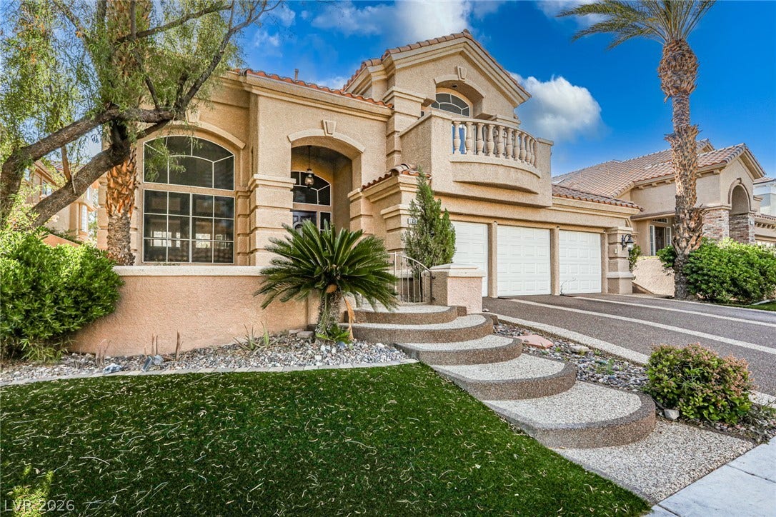 1828 Dolce Drive, Las Vegas, NV 89134 Elegant stucco facade with a grand arched entry and a private second-story balcony awaits.