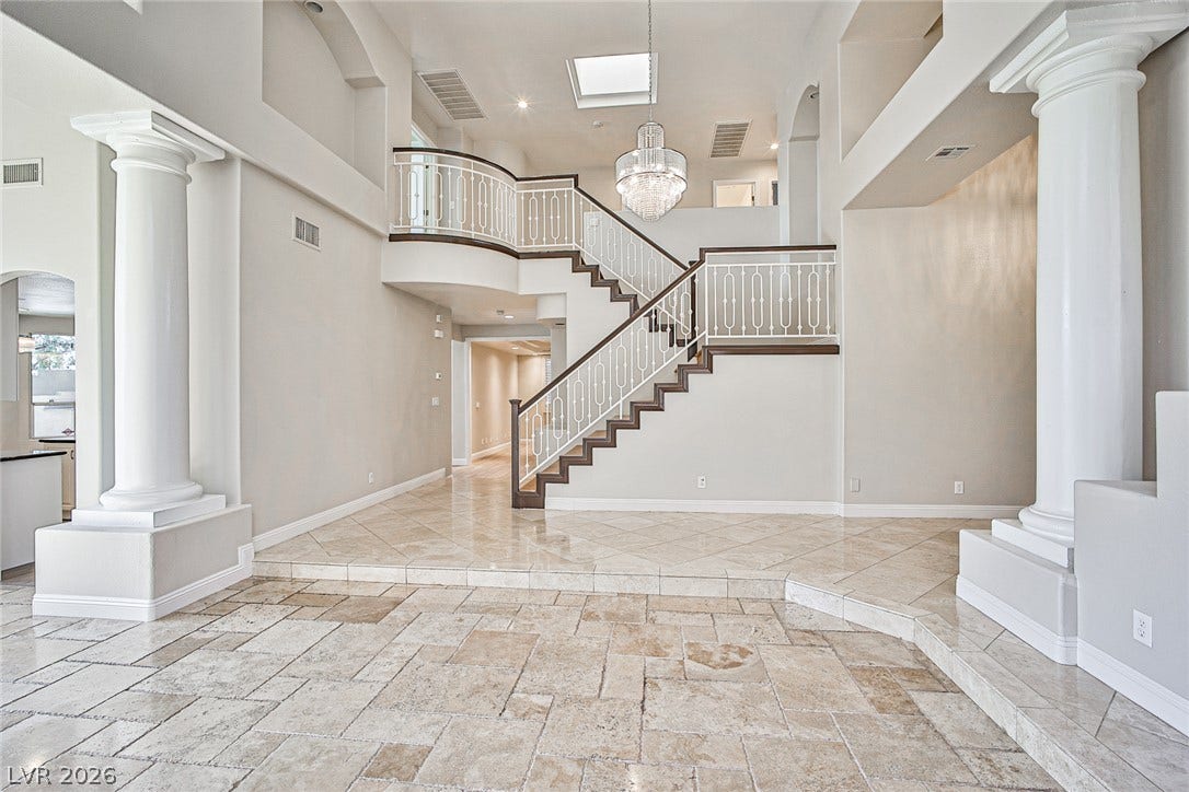 1828 Dolce Drive, Las Vegas, NV 89134 Grand two-story foyer featuring an elegant staircase and exquisite tile flooring.