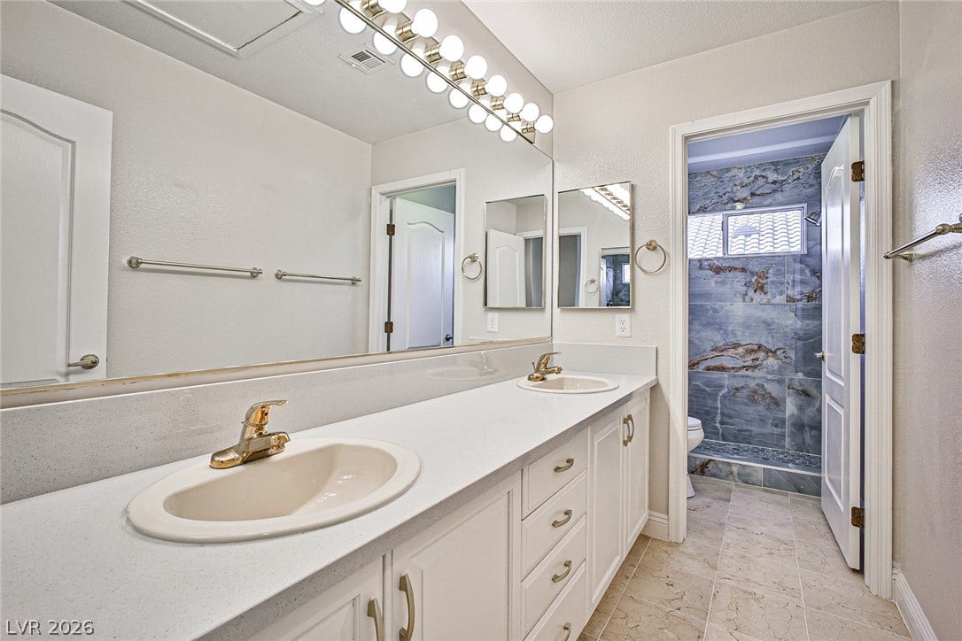 1828 Dolce Drive, Las Vegas, NV 89134 Double vanities with ample counter space await in this well-appointed bath.
