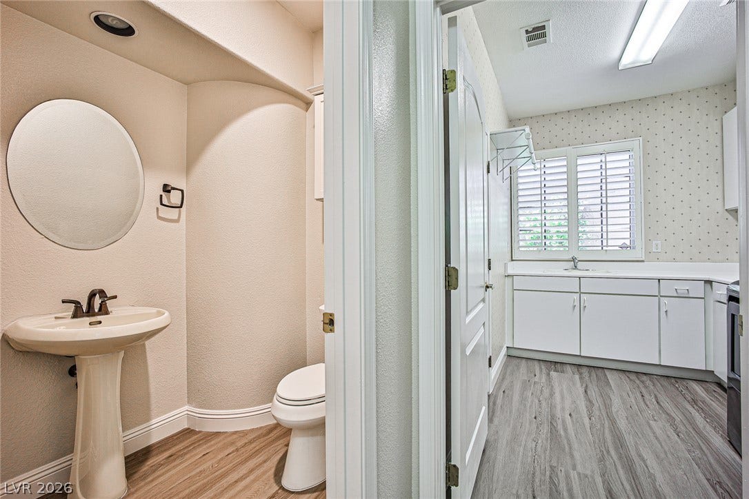 1828 Dolce Drive, Las Vegas, NV 89134 Functional layout combining a well-appointed utility space with an adjacent half-bath, featuring modern flooring and ample natural light.