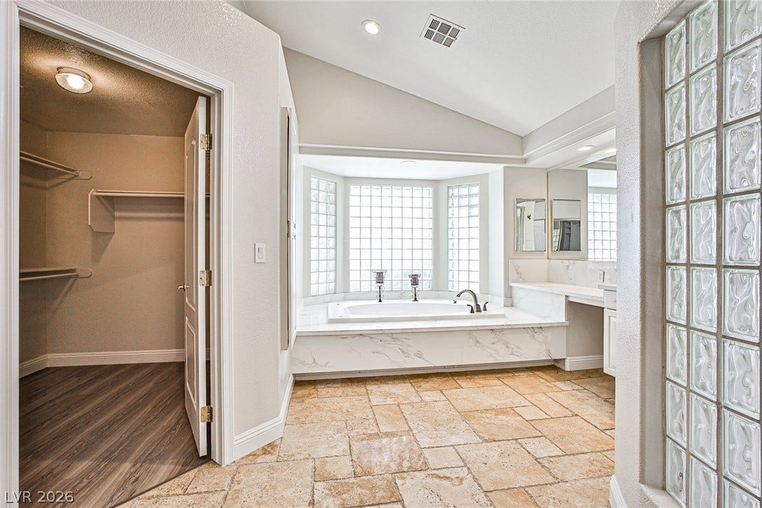 1828 Dolce Drive, Las Vegas, NV 89134 Indulge in a primary bathroom featuring a generous soaking tub, dual vanities, and a convenient walk-in closet.