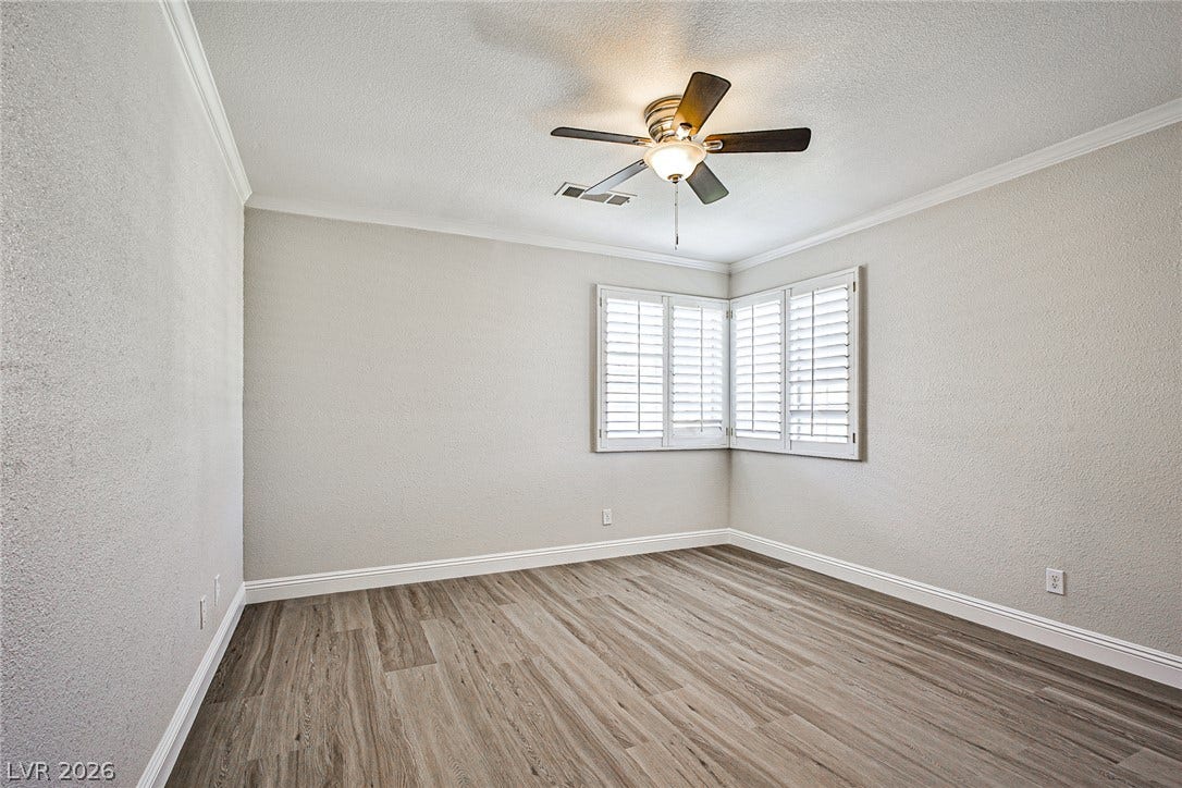 1828 Dolce Drive, Las Vegas, NV 89134 Clean lines and wood-like flooring define this adaptable room, ideal for personalized comfort.