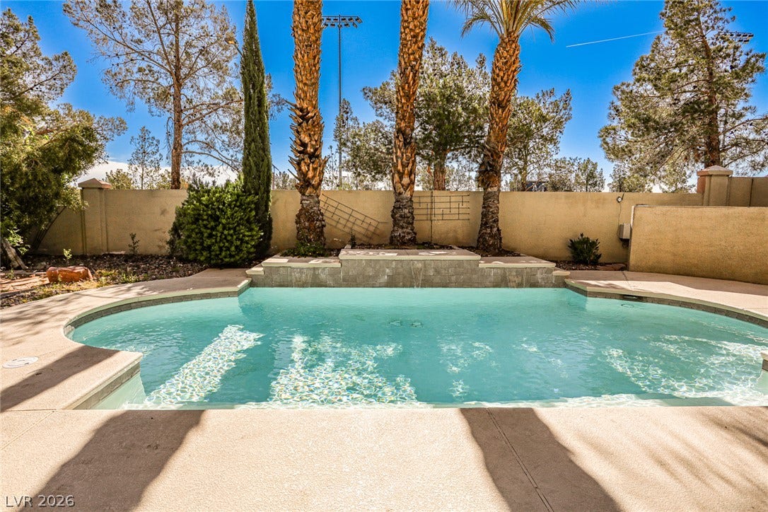 1828 Dolce Drive, Las Vegas, NV 89134 An inviting private pool and waterfall feature create a backyard oasis for ultimate relaxation.