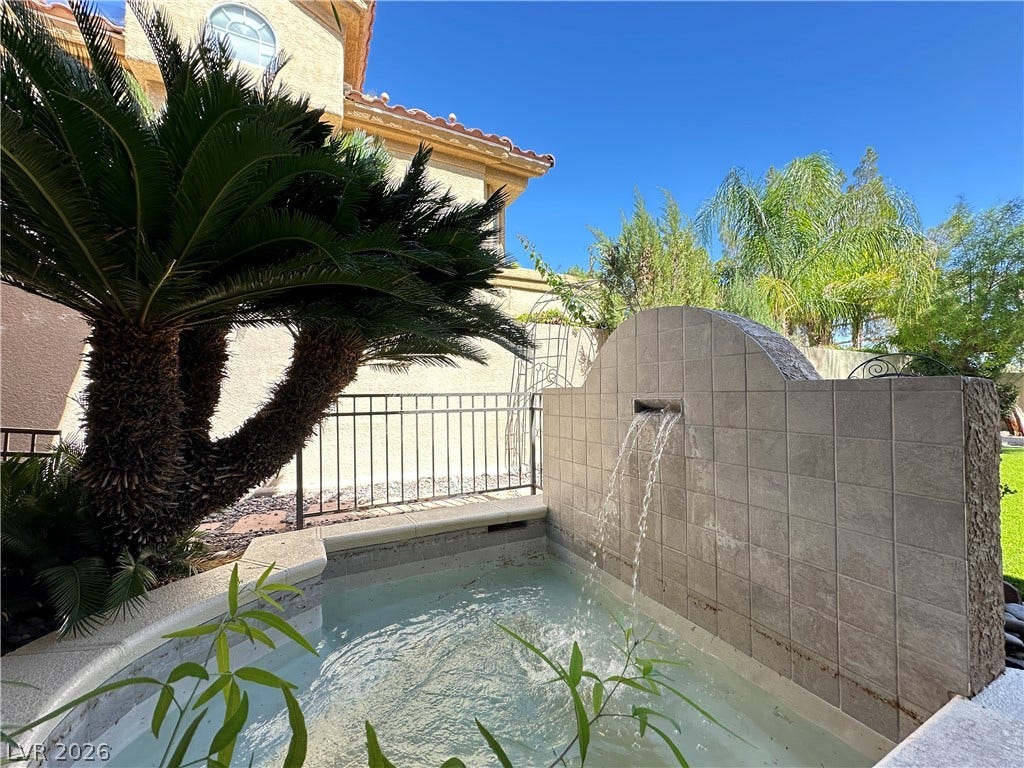 1828 Dolce Drive, Las Vegas, NV 89134 A tranquil oasis awaits with this charming courtyard featuring a flowing water feature.