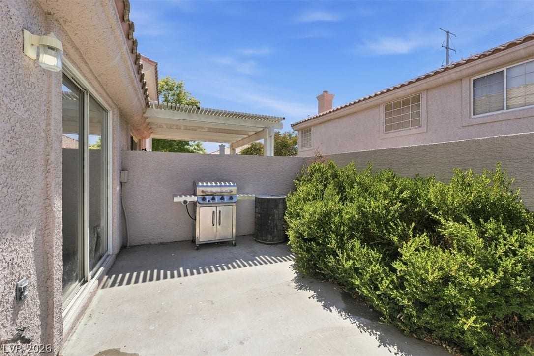 505 Rafkin Place, Henderson, NV 89052 A private outdoor space with a paved patio and mature landscaping, ideal for al fresco dining.