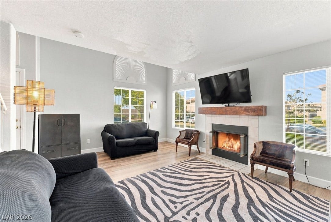 505 Rafkin Place, Henderson, NV 89052 A welcoming living area boasts light wood flooring and a classic tile fireplace with a robust wood mantle.