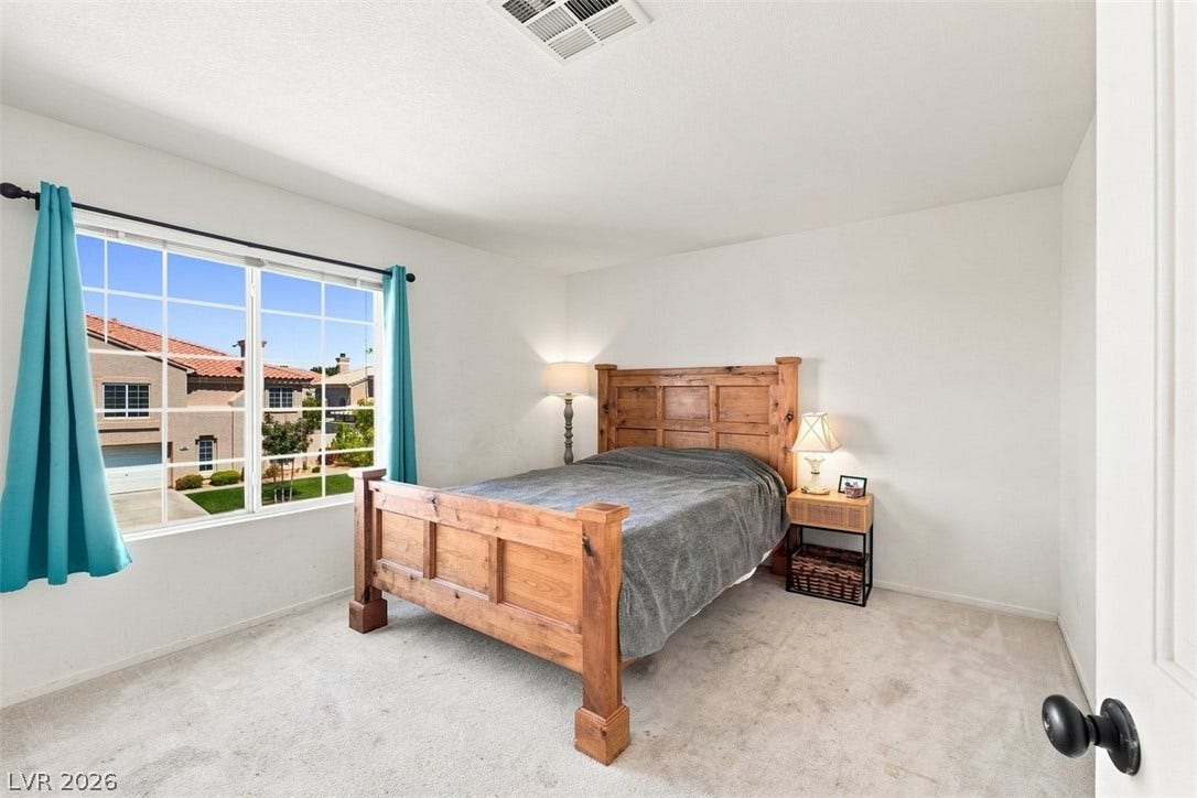 505 Rafkin Place, Henderson, NV 89052 A well-lit bedroom features a large window offering neighborhood views.