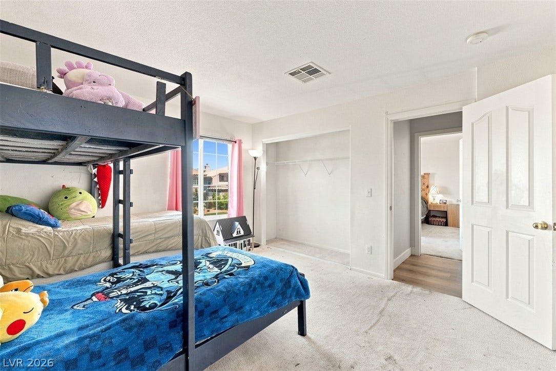 505 Rafkin Place, Henderson, NV 89052 A well-lit bedroom provides comfortable sleeping arrangements with bunk beds and ample closet space.