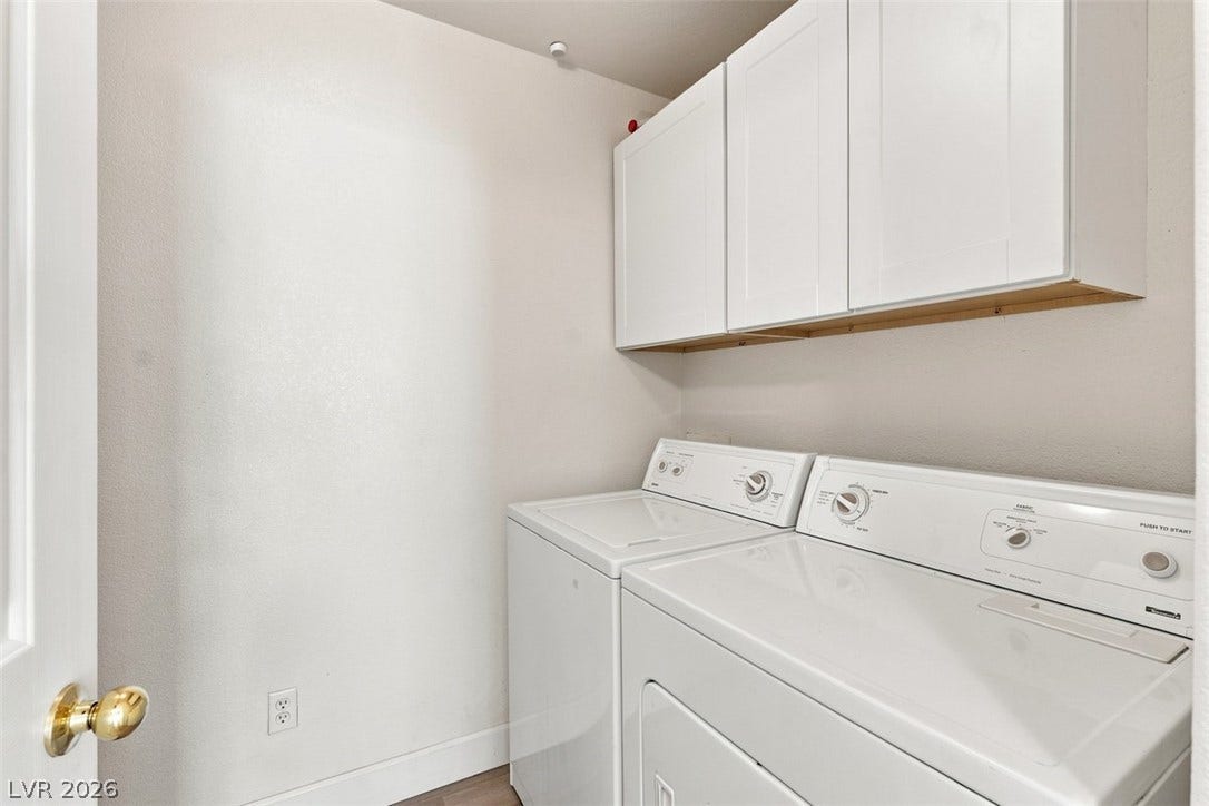 505 Rafkin Place, Henderson, NV 89052 Functional laundry room equipped with upper cabinetry and a washer/dryer set.