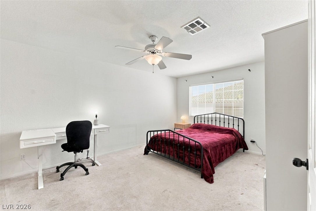 505 Rafkin Place, Henderson, NV 89052 A well-lit primary room offers a comfortable bed and a dedicated workspace, perfect for rest or productivity.