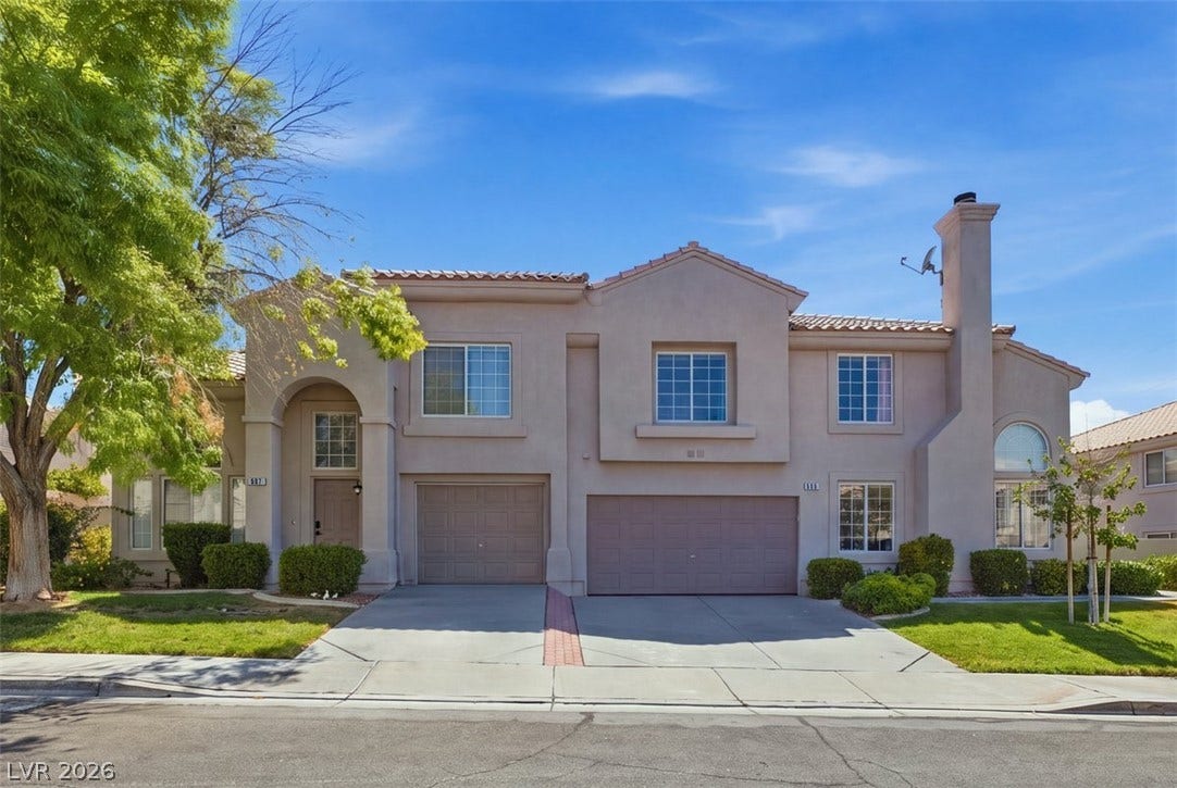 505 Rafkin Place, Henderson, NV 89052 A graceful two-story stucco residence presents an inviting arched entryway and dual garage doors.