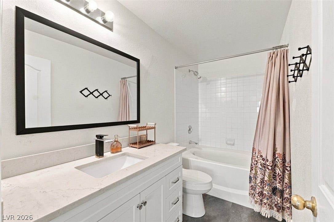 505 Rafkin Place, Henderson, NV 89052 Primary bathroom with white cabinetry with a polished countertop and an integrated sink define this inviting bathroom.