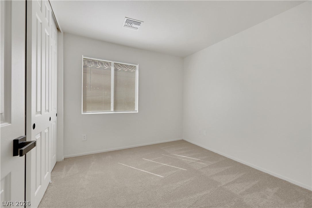 648 Moonlight Mesa Drive, Henderson, NV 89011 A well-lit bedroom provides ample space and a clean canvas for personalized comfort.