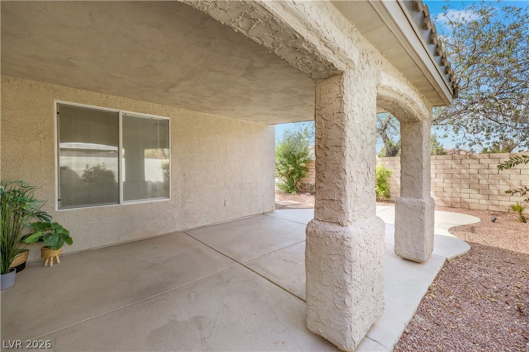 648 Moonlight Mesa Drive, Henderson, NV 89011 A spacious covered patio provides a shaded outdoor living area with direct yard access.