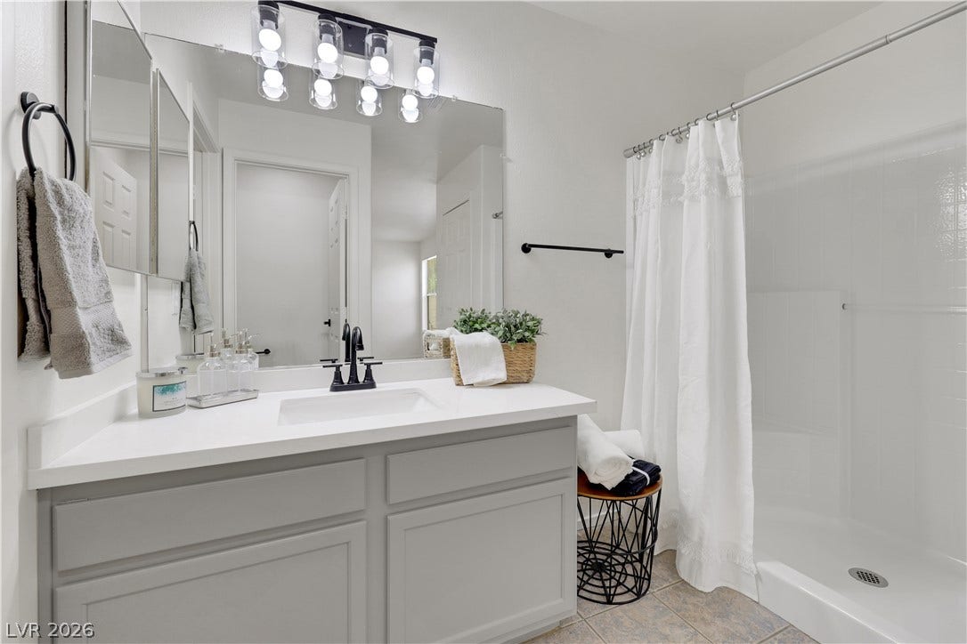 648 Moonlight Mesa Drive, Henderson, NV 89011 A well-appointed bathroom with a spacious vanity and modern fixtures awaits.