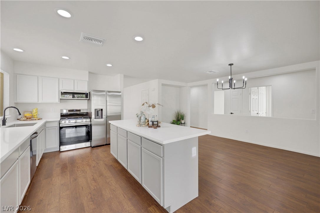 648 Moonlight Mesa Drive, Henderson, NV 89011 An open-concept kitchen boasts a large center island and stainless steel appliances, perfect for entertaining.