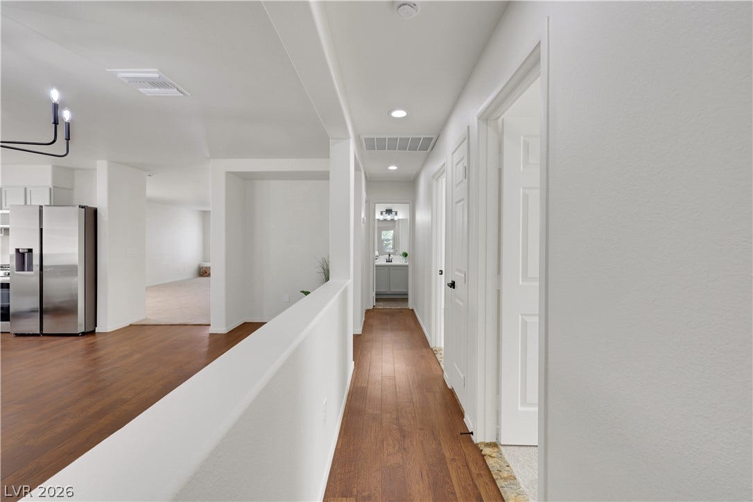 648 Moonlight Mesa Drive, Henderson, NV 89011 Rich hardwood floors guide you through this inviting hallway, leading to well-appointed living spaces.