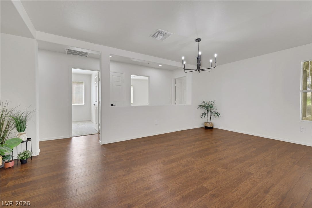 648 Moonlight Mesa Drive, Henderson, NV 89011 An open floorplan with rich wood flooring creates a welcoming ambiance.