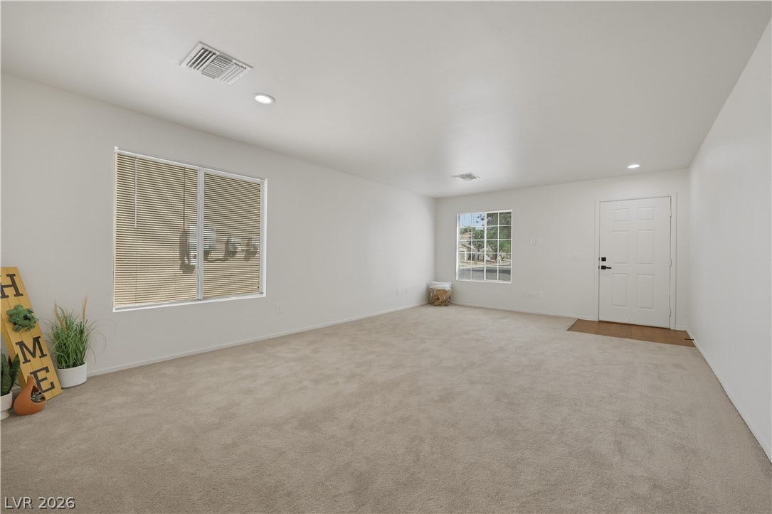 648 Moonlight Mesa Drive, Henderson, NV 89011 Inviting entry space with plush carpeting and natural light from large windows.