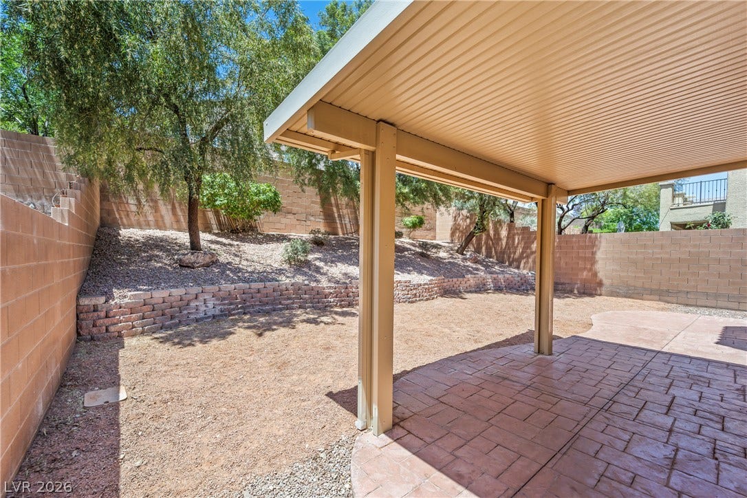 7337 Picnic Hill Street, Las Vegas, NV 89166 A spacious backyard with a covered patio offers ample room for outdoor activities and relaxation.