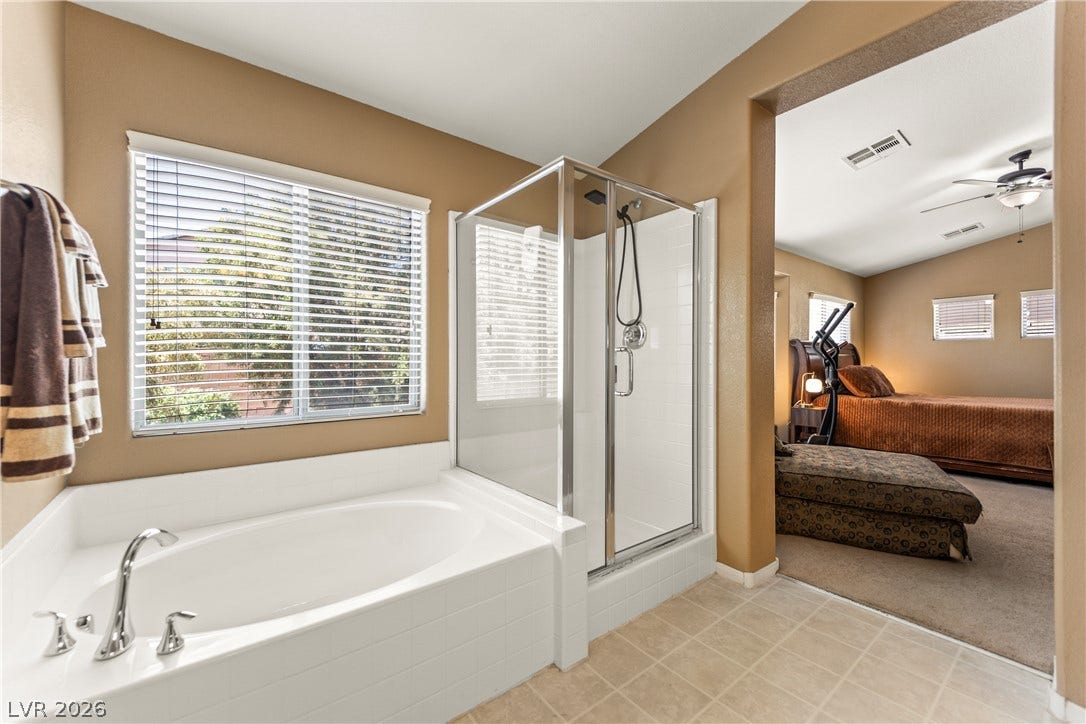 7337 Picnic Hill Street, Las Vegas, NV 89166 Relax in the corner soaking tub, conveniently adjacent to a refreshing glass-enclosed shower.