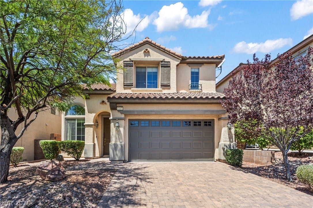 7337 Picnic Hill Street, Las Vegas, NV 89166 A charming stucco home with a tile roof and paver driveway offers inviting curb appeal.