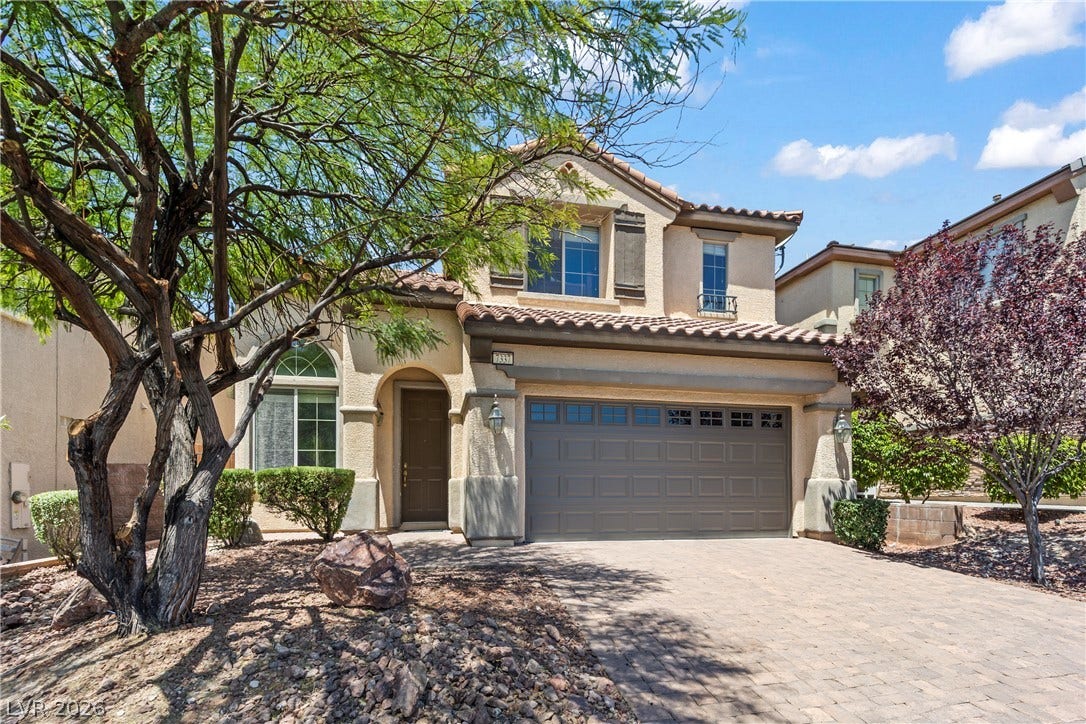 7337 Picnic Hill Street, Las Vegas, NV 89166 A well-maintained two-story home presents an inviting facade with a paver driveway, an integrated garage, and verdant landscaping.