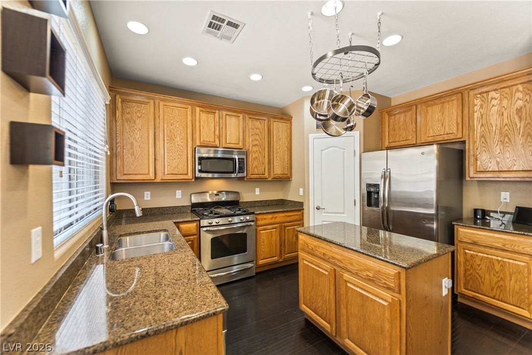 7337 Picnic Hill Street, Las Vegas, NV 89166 Well-appointed kitchen features abundant cabinetry, granite countertops, and modern stainless steel appliances.