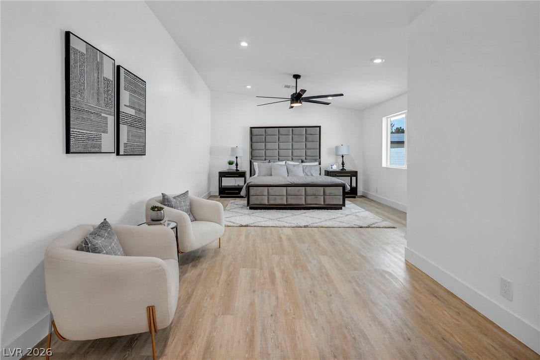 3630 Tobias Lane, Las Vegas, NV 89120 A spacious bedroom features light wood-look flooring and a modern ceiling fan for comfort.