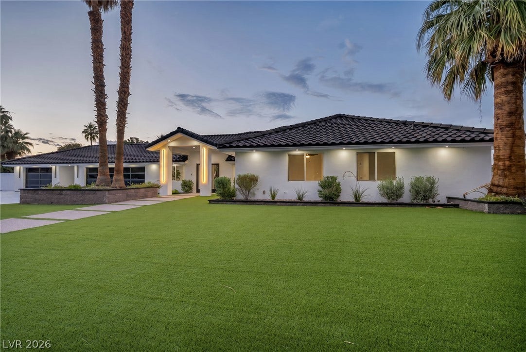 3630 Tobias Lane, Las Vegas, NV 89120 A striking modern residence boasts an expansive artificial turf lawn and tasteful exterior lighting.