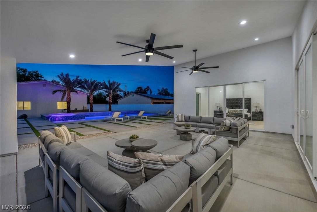 3630 Tobias Lane, Las Vegas, NV 89120 An inviting outdoor living area seamlessly connects to the illuminated pool and serene landscape.