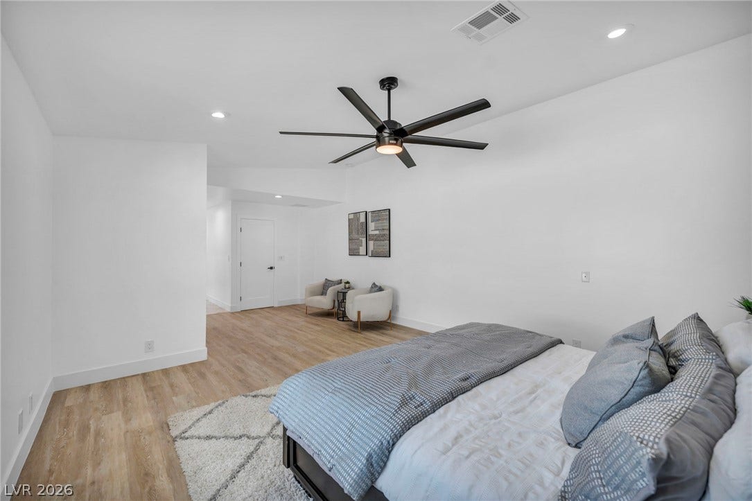 3630 Tobias Lane, Las Vegas, NV 89120 A generous primary bedroom with a contemporary ceiling fan and light-toned flooring, offering a spacious and serene retreat.