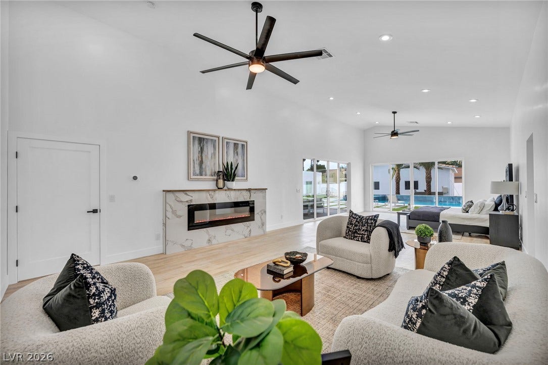 3630 Tobias Lane, Las Vegas, NV 89120 A grand room with vaulted ceilings and large glass doors leads to a sparkling pool.