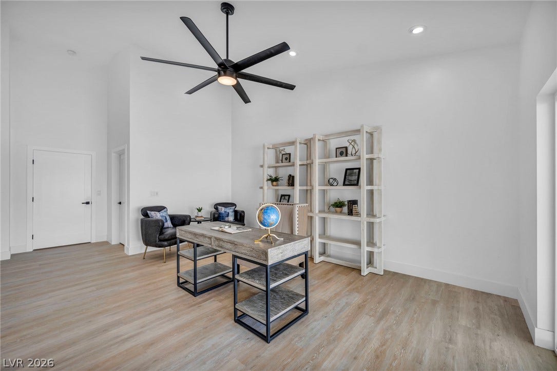 3630 Tobias Lane, Las Vegas, NV 89120 Lofty ceilings and sleek wood-look flooring define this versatile home office space, perfect for productivity.