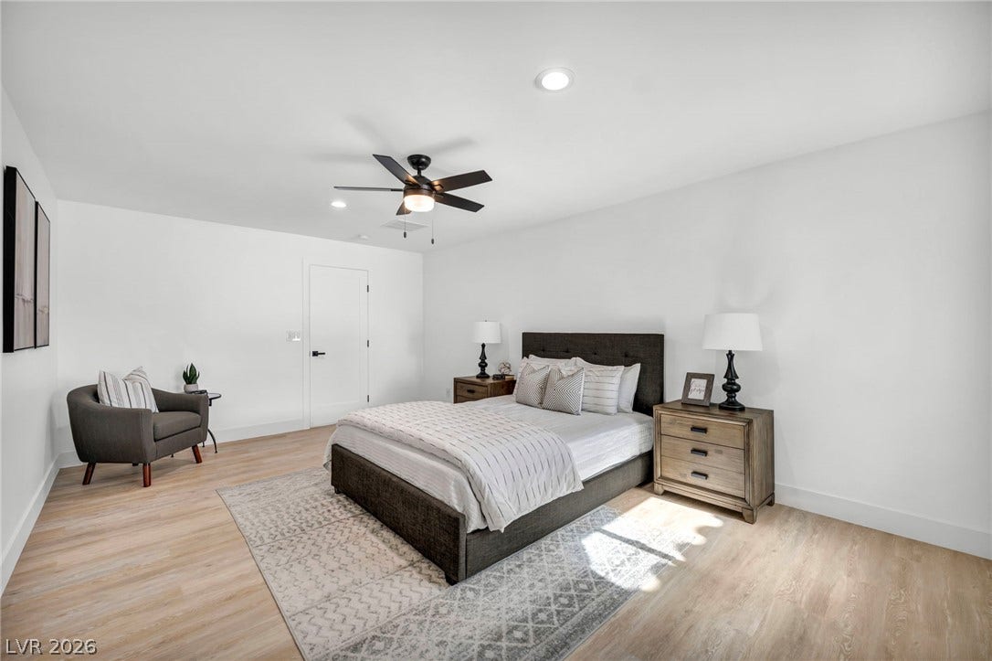 3630 Tobias Lane, Las Vegas, NV 89120 A tranquil sleeping space awaits, featuring wide plank flooring and a modern ceiling fan for ultimate comfort.