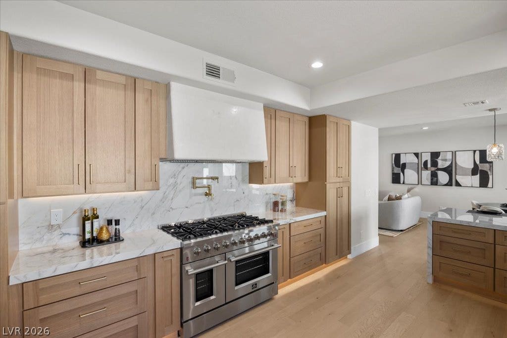 8024 Shorecrest Drive, Las Vegas, NV 89128 Culinary delights await in this modern kitchen, showcasing a professional-grade range and seamless marble countertops.