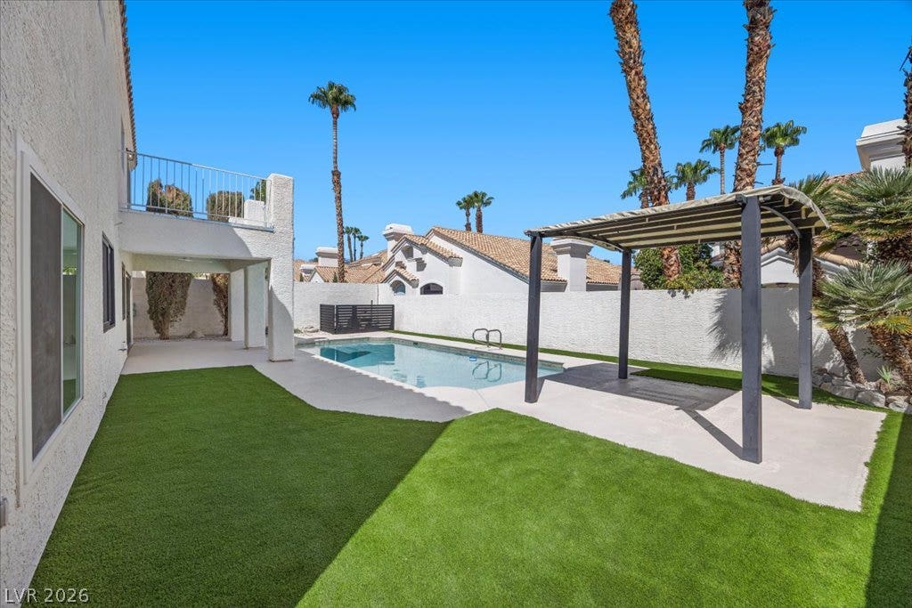 8024 Shorecrest Drive, Las Vegas, NV 89128 A well-maintained turf yard and sparkling pool create an inviting outdoor oasis.