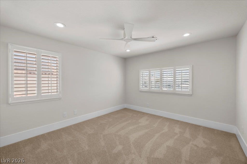 8024 Shorecrest Drive, Las Vegas, NV 89128 A quiet retreat, this bedroom offers plush carpeting and ample natural light through well-appointed window shutters.