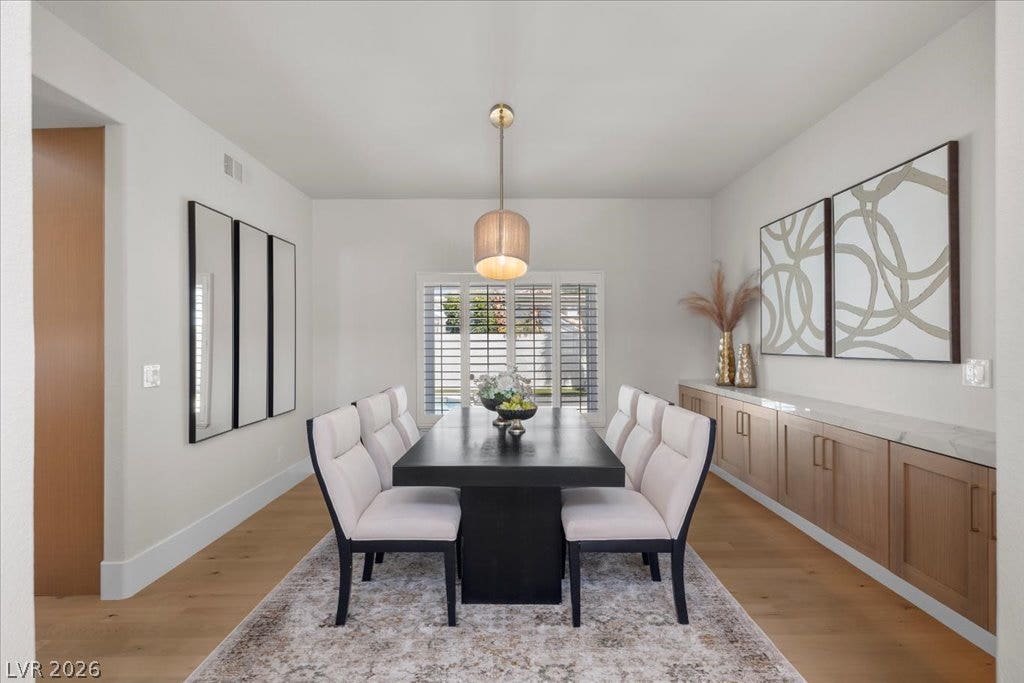 8024 Shorecrest Drive, Las Vegas, NV 89128 A gracefully appointed dining room awaits, featuring light wood floors and ample natural light.
