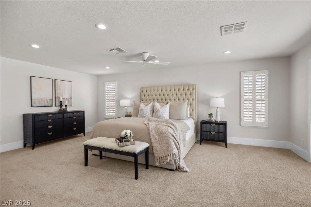 8024 Shorecrest Drive, Las Vegas, NV 89128 Step into this spacious primary bedroom, offering plush carpeting and abundant recessed lighting.