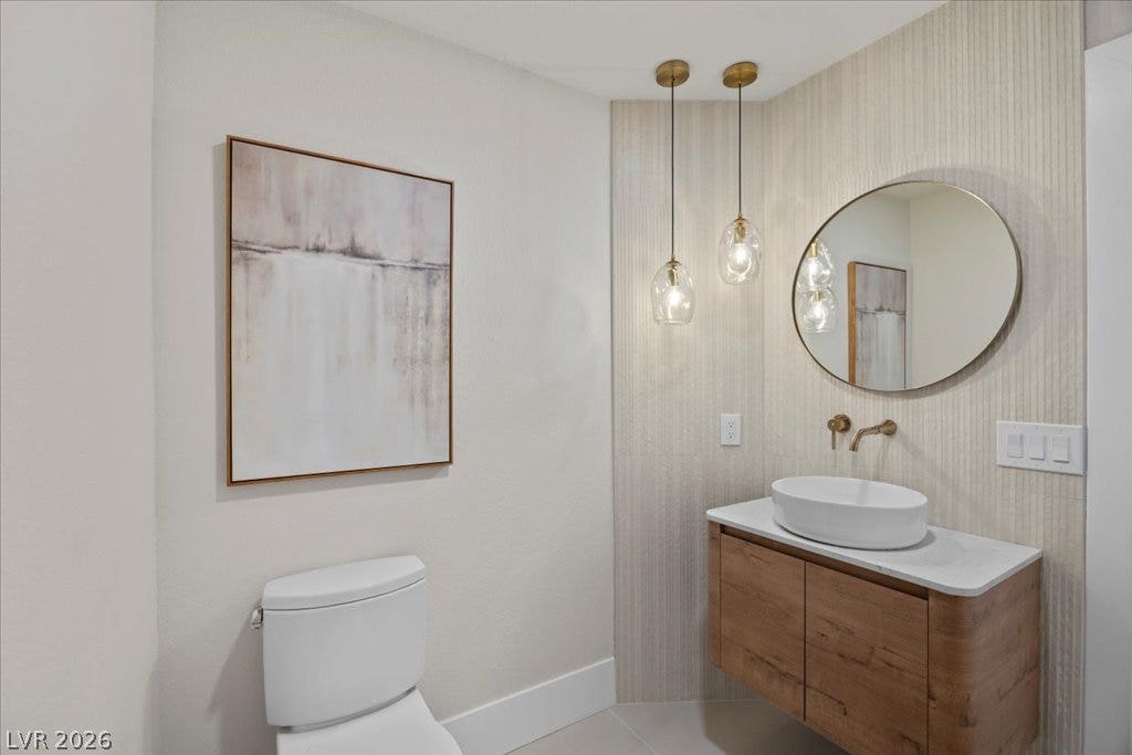 8024 Shorecrest Drive, Las Vegas, NV 89128 Modern bath boasts a floating vanity and brass fixtures, creating a clean, contemporary aesthetic.