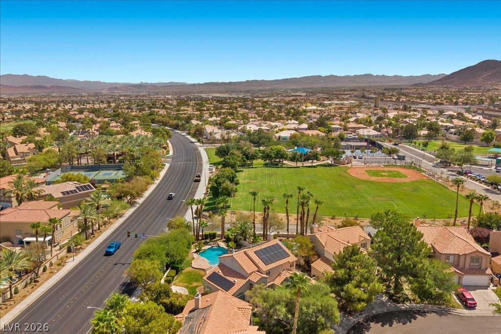 2000 Silverton Drive, Henderson, NV 89074 An aerial panorama reveals a vibrant community with recreational amenities and desert mountain vistas.